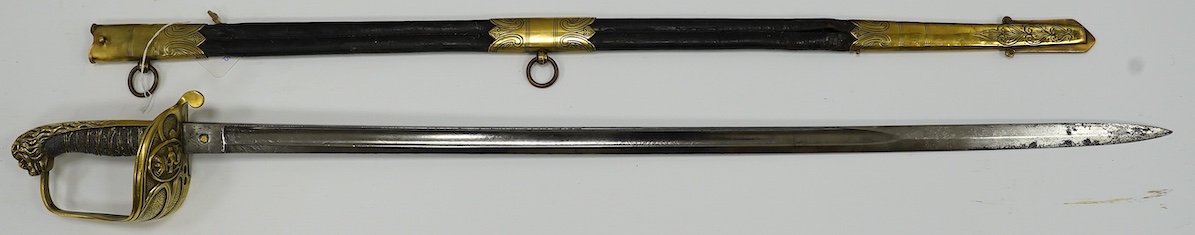 A Victorian warrant officer's sword by Westcott and Sons, regulation brass hilt, black fish skin covered grip, in its brass mounted leather scabbard, blade 79.5cm. Condition - well worn